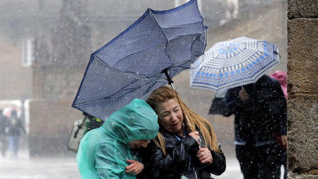 Peregrinos sorprendidos por la lluvia en Santiago. LAVANDEIRA JR