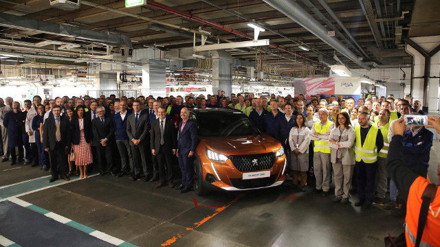 Autoridades y trabajadores, con la primera unidad del Peugeot 2008 fabricada en la planta de PSA en Vigo. EFE