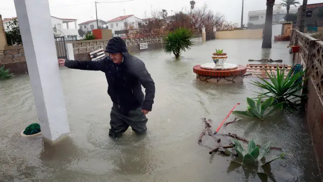 Un vecino intenta entrar en su casa de la localidad de Almenara (Castellón) tras el paso de la borrasca Gloria. EFE