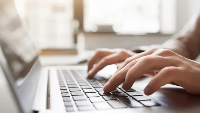 Typing on laptop closeup, chatting in Facebook, meeting website. Blogger, journalist writing new article.