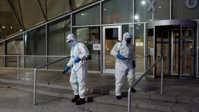 Dos operarios desinfectan ante los juzgados de Ourense. BRAIS LORENZO