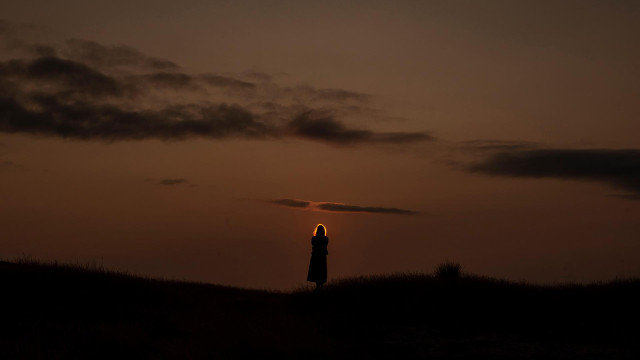 Unha muller observa a posta de sol na contorna do encoro de Salas (Muiños, Ourense). BRAIS LORENZO (EFE)