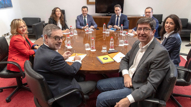 Los equipos negociadores de Partido Popular y Ciudadanos, encabezados por Juanma Moreno (c) y Juan Marín (2d). JULIO MUÑOZ (EFE)