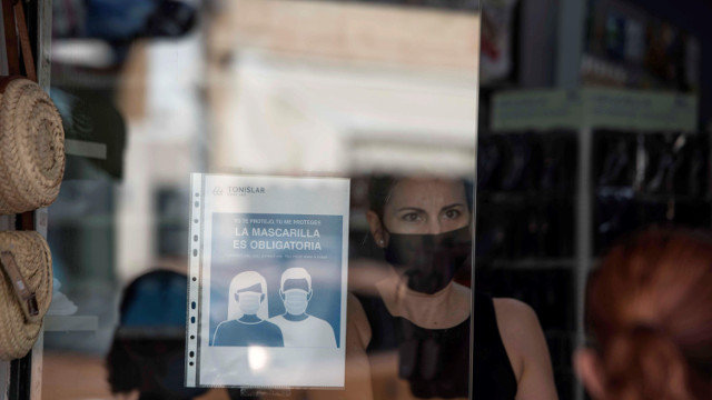 Un cartel que recuerda el uso obligatorio de mascarilla en una tienda. EFE