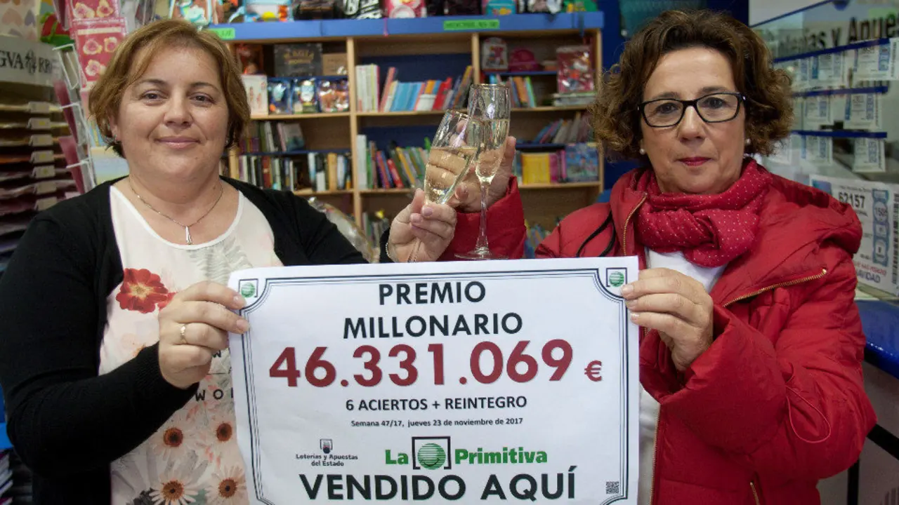 La propietaria y la empleada de la administración donde se validó el boleto, Mª Luisa Santos y Silvia Gonzalez brindan por el premio. SALVADOR SAS (EFE)