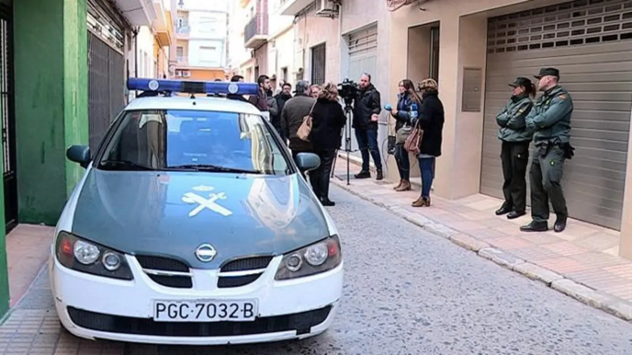 Una agente de la Guardia Civil custodia la vivienda de la mujer de 53 años que falleció anoche en Guadassuar después de que fuese agredida por su pareja sentimental, un hombre de 40 años que  fuese agredida por su pareja sentimental, un hombre de 40 años que ha sido detenido. EUSEBIO CALATAYUD (EFE)