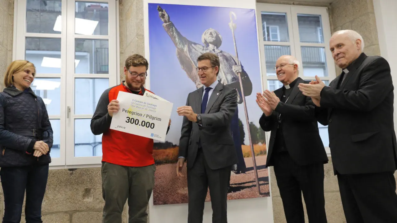 Nava Castro, Alberto Núñez Feijóo; el arzobispo Julián Barrio y el deán Segundo Pérez, entregan al peregrino  Andrew Patrick Larkin la acreditación como peregrino número 300.000. LAVANDEIRA JR (EFE)