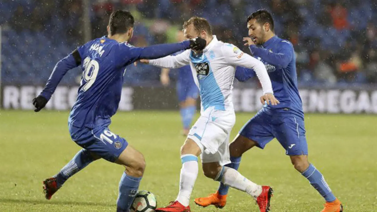 Krohn-Dehli, entre dos jugadores del Getafe. BALLESTEROS