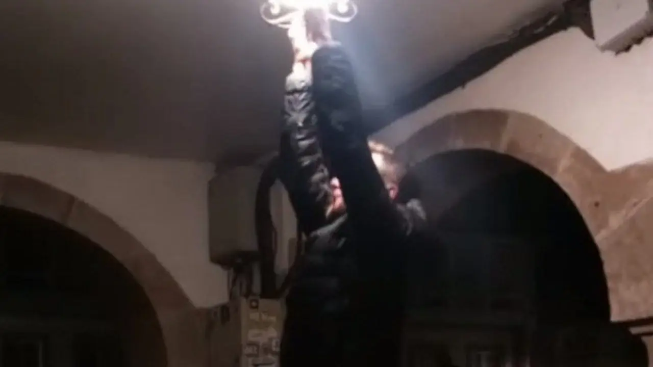 Un dos mozos, co farol de Santiago. TVG