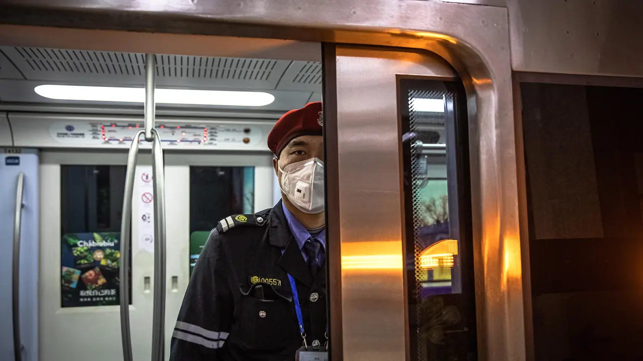 Un empleado del Metro en Beijin, con una mascarilla por el coronavirus. ROMAN PILIPEY