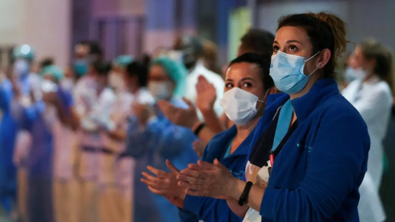 Persoal sanitario dun hospital madrileño responde aos aplausos dos cidadáns. EFE