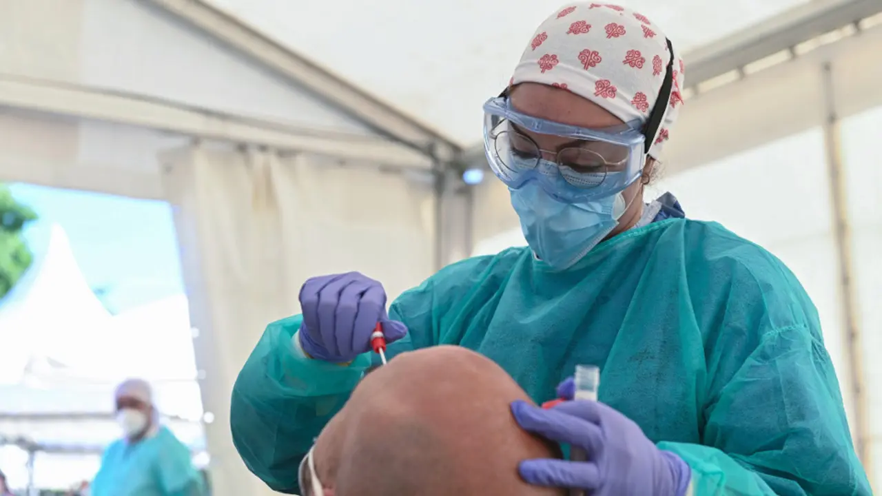 Una sanitaria realiza un test PCR a un hombre. EFE