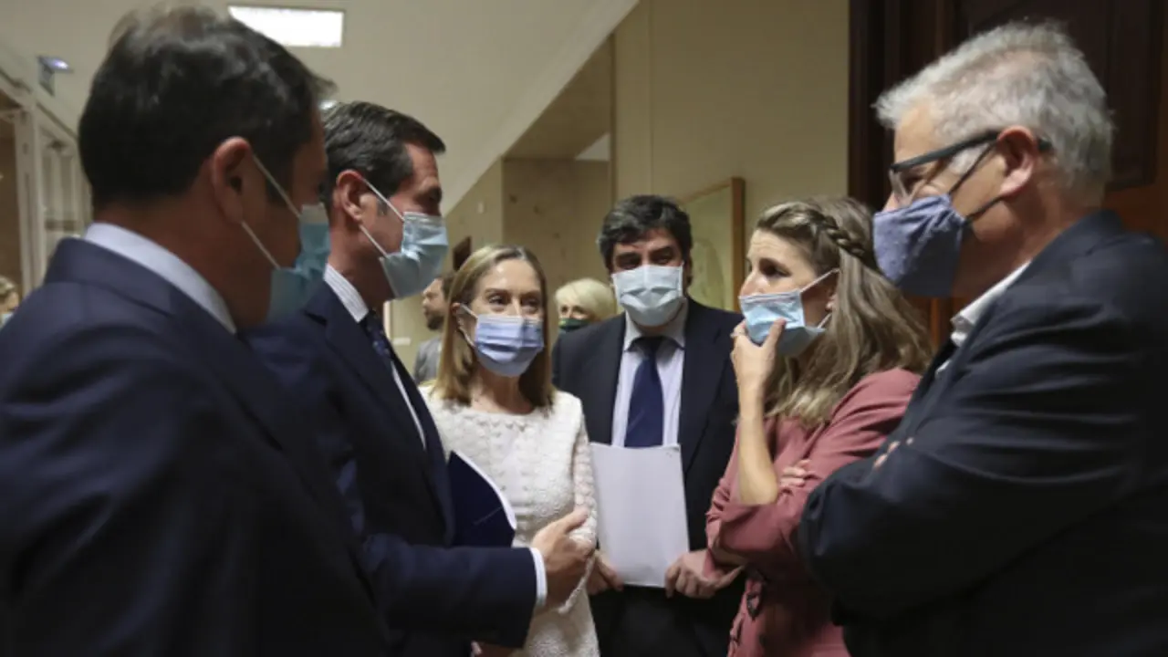 La ministra de Trabajo habla con los presidentes de Ceoe y Cepyme y varios diputados este jueves en el Congreso. KIKO HUESCA (Efe)