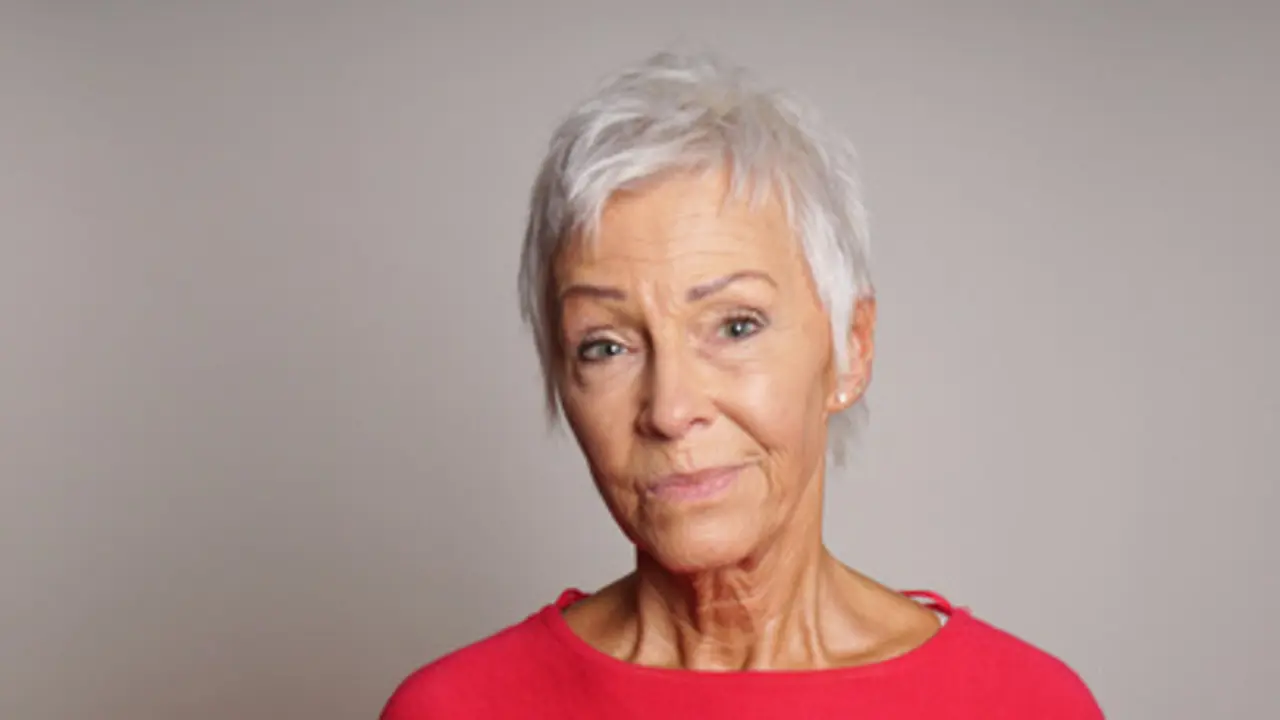 mature woman in her sixties with a skeptical look on her face