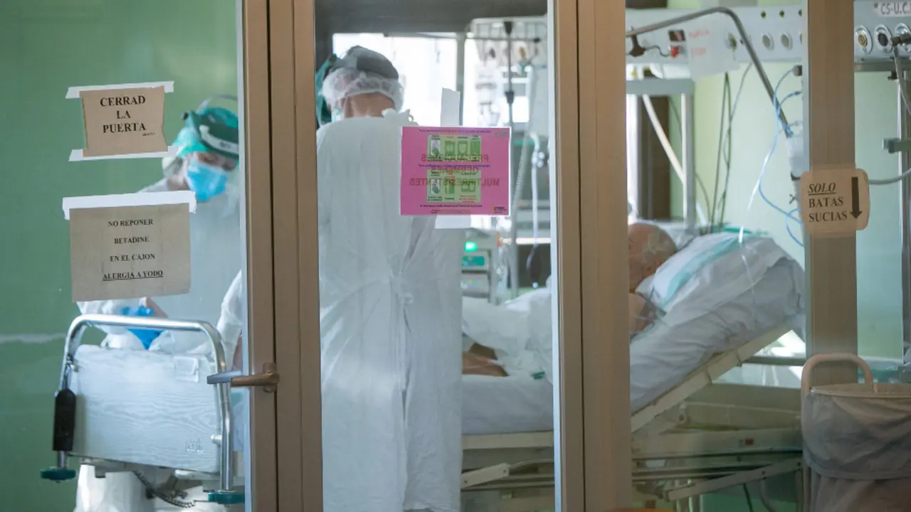 Dos sanitarios tratan a un paciente con covid-19 en una Uci. JAVIER CEBOLLADA (EFE)