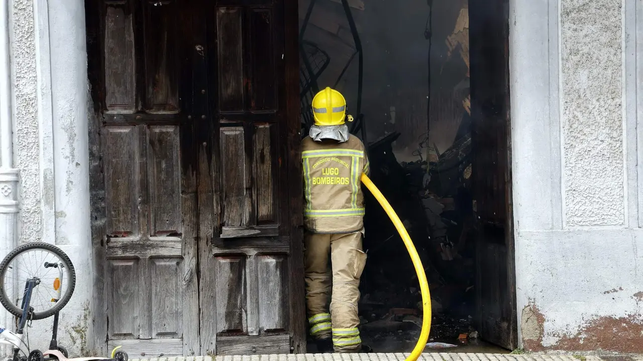 Incendio en dos viviendas de Rabade. Efectivos del cuerpo de bomberos trabajando en la extinción del fuego. XESÚS PONTE (AEP)