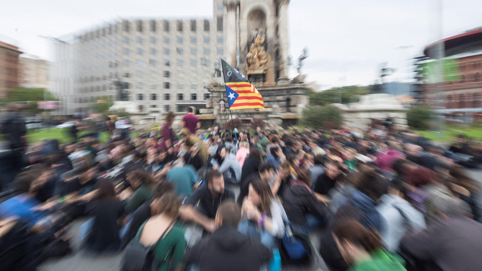 Un grupo de manifestantes realiza una sentada en la Plaza de España de Barcelona en la mañana de este viernes. MARTA PÉREZ (EFE)